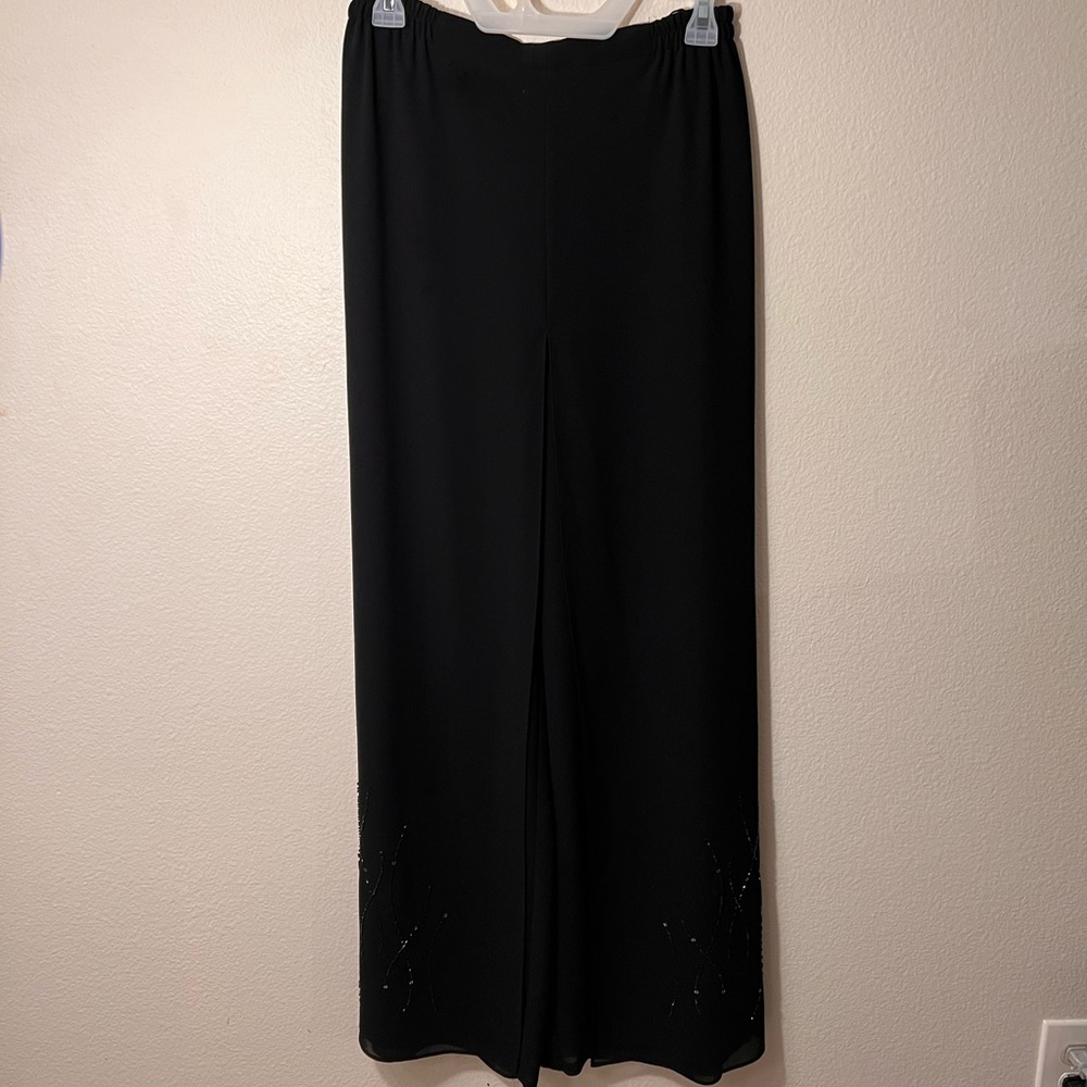Classy Flowey black pants with cute design at ankles. Looks like skirt in front
